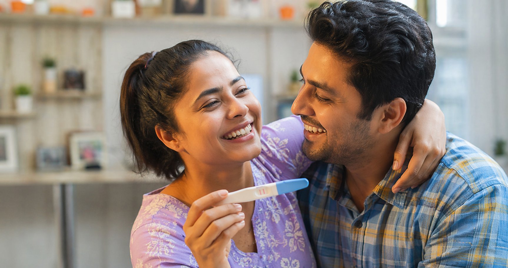 Indian couple celebrating positive pregnancy test